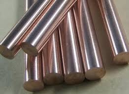 A cluster of polished solid copper rods with a metallic reddish-orange sheen.